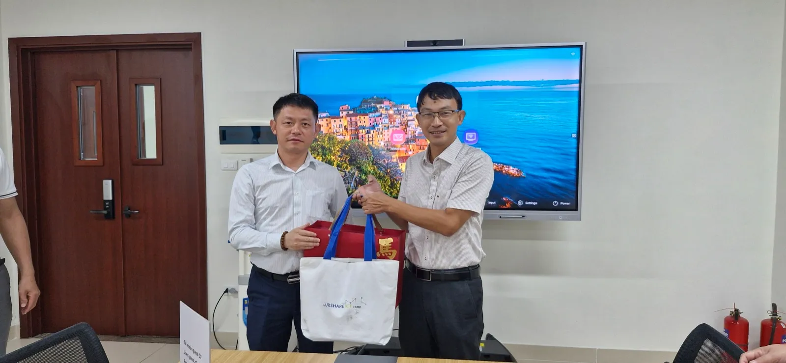 Đại diện Trường Điện - Điện tử và Luxshare ICT Nghệ An trao quà lưu niệm tại buổi làm việc